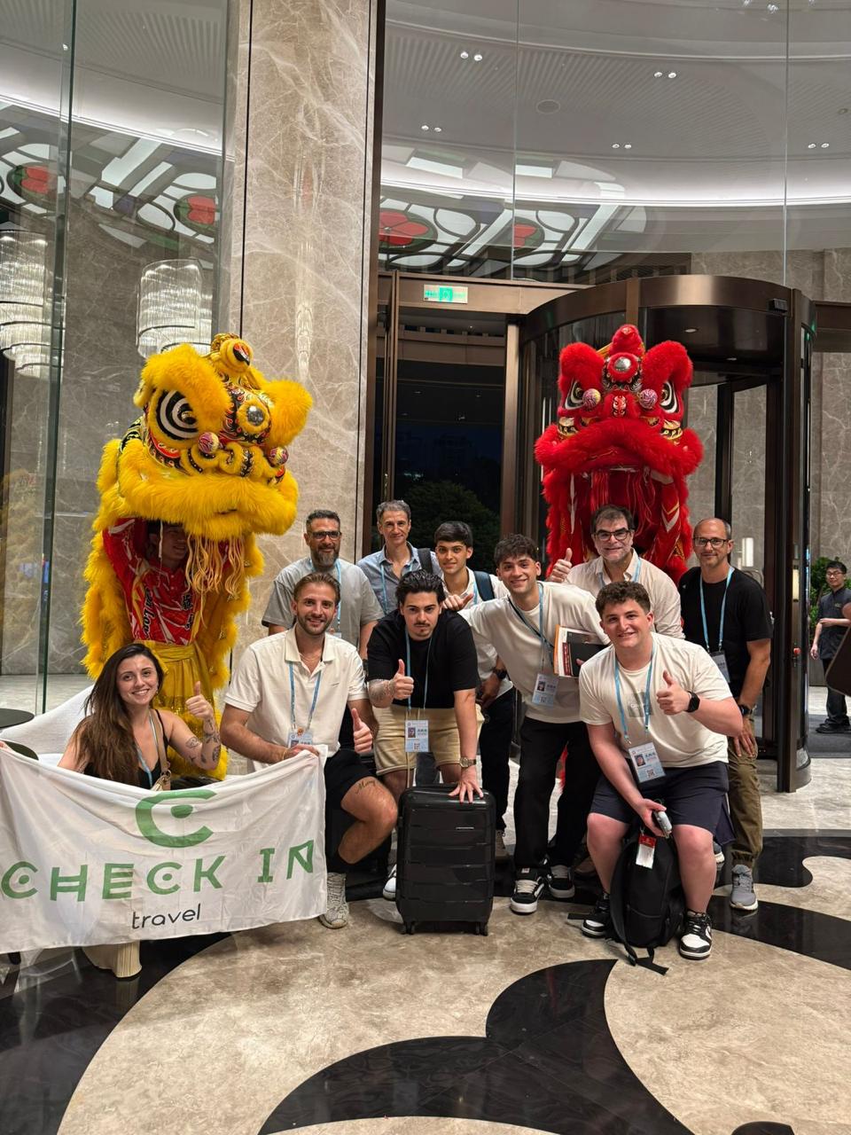 Grupo con leones chinos y banner de Check In Travel